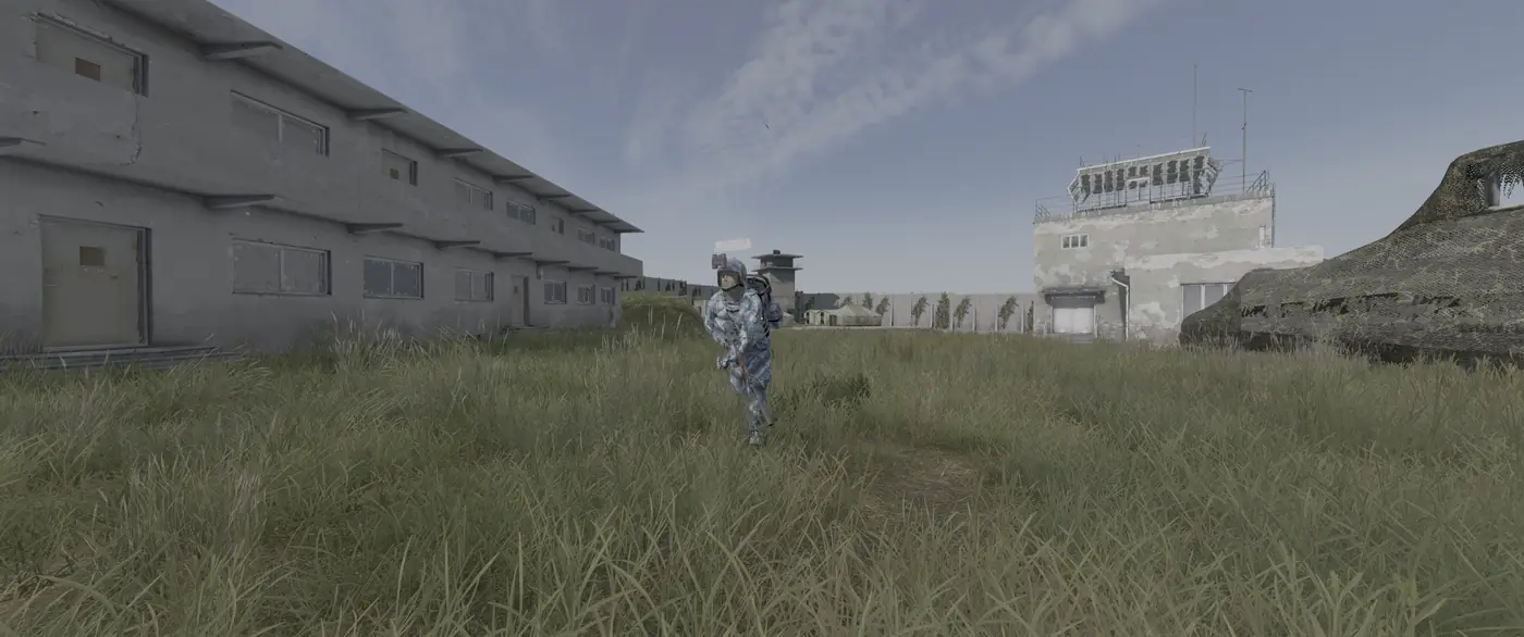 A survivor in winter camo running past barracks and an air traffic tower at a military base on Is Dead